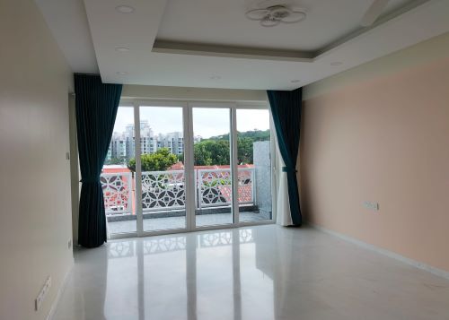 Room with floor to ceiling windows and curtains tied up at both sides of the windows