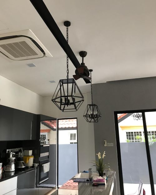 Kitchen with island, and two overhanging lighting decorations over the island
