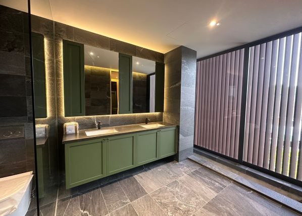 Bathroom with back lights installed behind mirrors above the sink