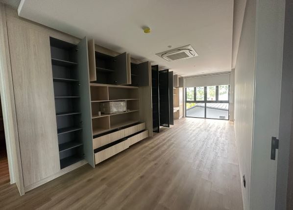Storeroom with multiple cabinets and drawers with wood finish