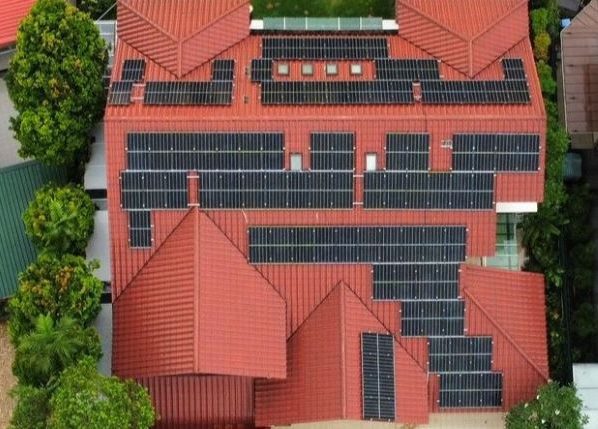 Top down view of a house with solar panels installed on the roof